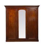 A VICTORIAN MAHOGANY TRIPLE WARDROBE with central mirrored door, two thirds of interior space fitted