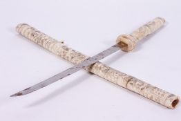 A JAPANESE SWORD with a carved bone grip and scabbard, blade 41cm in length, overall 76cm in