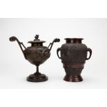 AN ORIENTAL BRONZE URN with elephant trunk handles,19cm in height together with a spelter urn,