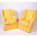 A PAIR OF YELLOW UPHOLSTERED WING BACK ARMCHAIRS each 75cm wide x 75cm deep x 98cm high Condition: