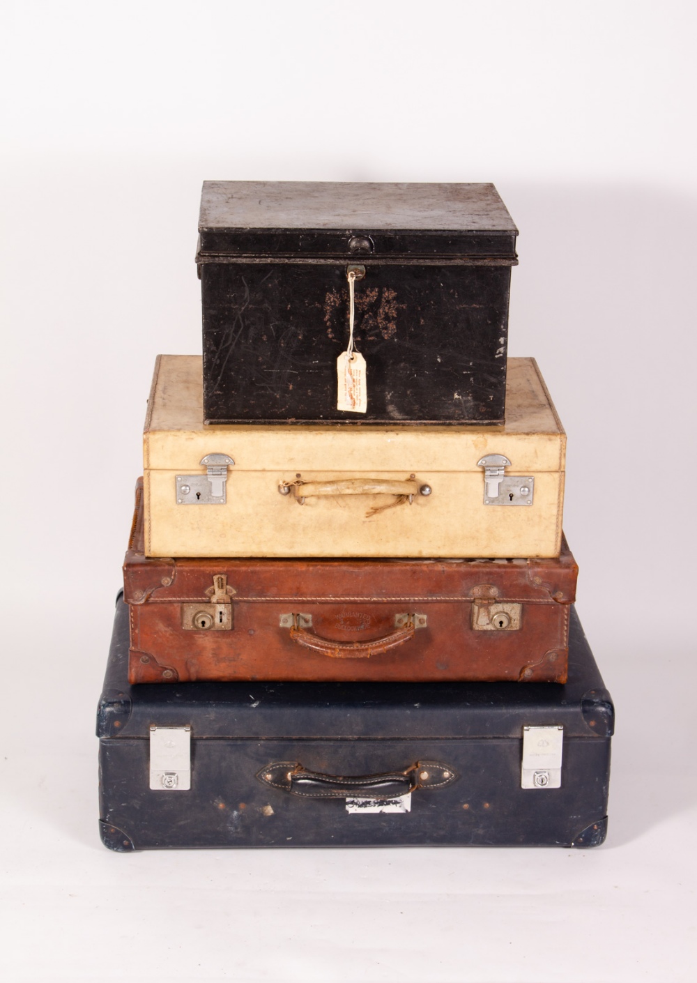 AN OLD LEATHER SUITCASE stamped 'Warranted Bullock Hide', 61cm wide together with a velum covered