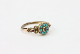 A VICTORIAN TURQUOISE, RUBY AND PEARL INSET YELLOW METAL RING the ring 19mm diameter Condition: