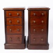A PAIR OF VICTORIAN MAHOGANY NARROW CHESTS OF FOUR SHORT DRAWERS with turned knob handles and plinth