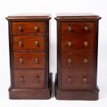 A PAIR OF VICTORIAN MAHOGANY NARROW CHESTS OF FOUR SHORT DRAWERS with turned knob handles and plinth