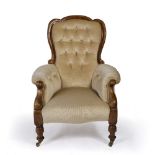 A VICTORIAN WALNUT FRAMED ARMCHAIR with shaped button upholstered back, scrolling arms and cream