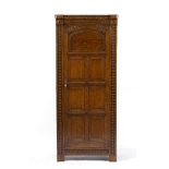 AN EARLY TO MID 20TH CENTURY OAK HALL CUPBOARD in the 17th century style, with panelled single