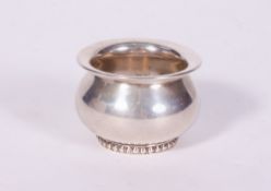 A 835 WHITE METAL BOWL of squat form, with makers mark to the base, 6.4cm wide x 4.5cm high,