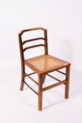 ATTRIBUTED TO GORDON RUSSELL A caned walnut bedroom chair or child's chair, 40.5cm wide x 39cm