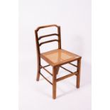 ATTRIBUTED TO GORDON RUSSELL A caned walnut bedroom chair or child's chair, 40.5cm wide x 39cm