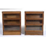 A NEAR PAIR OF OAK GLOBE WERNICKE STYLE THREE TIER GLAZED BOOKCASES one with a label for Simpoles