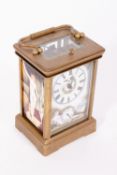 AN ORIENTAL BRASS CASED CARRIAGE CLOCK with enamel decorated panels to the side and dial with