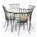 A WROUGHT IRON AND BRASS DINING SUITE consisting of a circular glass inset table with brass rim