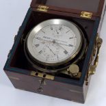 A MARINE CHRONOMETER by Brock, 21 George Street, Portman Square, London, set within a brass bound