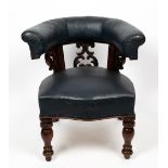 A LIBRARY ARMCHAIR with horseshoe back on carved supports and with blue leatherette upholstered back