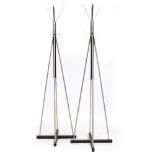 A PAIR OF BRUSHED STEEL AND BLACK PAINTED WOODEN COAT RACKS each with splaying hooks and on cross