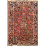 AN EARLY 20TH CENTURY PERSIAN BLUE AND RED GROUND RUG with stylised foliate and peacock