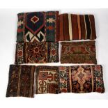 SEVEN CUSHIONS upholstered in Middle Eastern rug fragments to include two Kelim examples, the