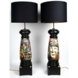 A PAIR OF BLACK PAINTED LARGE TURNED WOODEN TABLE LAMPS with collage decoration, 87cm high overall