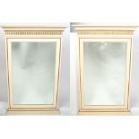 A PAIR OF CONTEMPORARY CREAM PAINTED PARCEL GILT RECTANGULAR WALL MIRRORS with shaped cornice and
