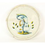 AN 18TH CENTURY CONTINENTAL TIN GLAZED TAZZA centrally decorated with a figure holding a banner,