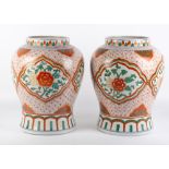 A PAIR OF ORIENTAL PORCELAIN BALUSTER VASES with cartouches depicting chrysanthemums, 27cm