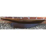 A VARNISHED WOODEN MODEL YACHT HULL 123cm long x 25cm wide x 25cm deep Condition: reasonable