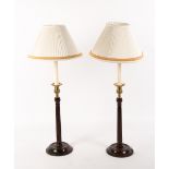 A PAIR OF GEORGIAN STYLE MAHOGANY AND BRASS TABLE LAMPS with circular spreading bases and fluted