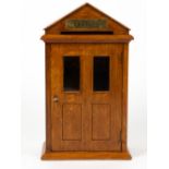 AN OAK COUNTRY HOUSE LETTERS BOX of architectural form with single glazed door, 22.5cm wide x 14cm