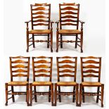 A SET OF EIGHT ASH LADDER BACK DINING CHAIRS with rush seats, turned front legs terminating in pad