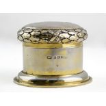 A GEORGE V SILVER GILT DRESSING TABLE BOX by the Duchess of Sutherland's Cripples Guild, the lid