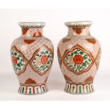 A PAIR OF ORIENTAL PORCELAIN BALUSTER VASES with flaring rims, the cartouches decorated with