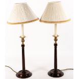 A PAIR OF GEORGIAN STYLE MAHOGANY AND BRASS TABLE LAMPS with fluted columns and circular spreading