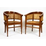 A PAIR OF COLONIAL STYLE HARDWOOD HORSESHOE SHAPED CHAIRS with caned back and seat and turned