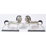 A PAIR OF ART DECO SCULPTURES depicting prancing horses, cast white metal and with painted manes,