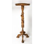 A 19TH CENTURY AND LATER CARVED WOODEN TORCHERE possibly limewood, the shaped serpentine top on a