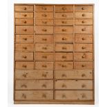 A PINE CHEST OF THIRTY EIGHT SPICE DRAWERS with turned knob handles, 92.5cm wide x 24cm deep x 115cm