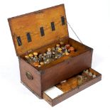 A 19TH CENTURY OAK CASED APOTHECARY OR MEDICINE CHEST containing a number of glass bottles,