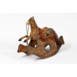 A 19TH CENTURY PAINTED PINE AND PAPIER MACHE ROCKING HORSE 101cm wide x 77cm high Condition: one ear