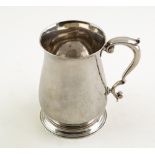 A GEORGE III SILVER BALUSTER PINT TANKARD with scrolling handle, stepped circular base, with