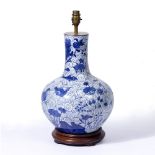 A BLUE AND WHITE PORCELAIN BALUSTER SHAPED TABLE LAMP decorated with fish, lilies, birds and