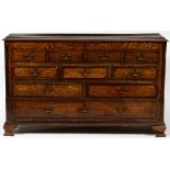 A GEORGE III OAK MULE CHEST with a lifting top, four faux drawers, three short drawers, two long