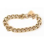 A 9 CARAT GOLD CURB LINK BRACELET with a 9 carat gold heart locket, 57 grams in weight Condition: in