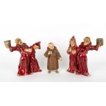 A PAIR OF EARLY 20TH CENTURY AUSTRIAN POTTERY CANDLESTICKS in the form of drunken monks, each 21cm