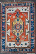 A MID TO LATE 20TH CENTURY TURKISH RED, BLUE AND WHITE GROUND CARPET with geometric decoration,