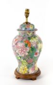 A BALUSTER PORCELAIN TABLE LAMP in the form of an Oriental vase and cover with turned wooden base,