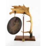 A GONG constructed from an antler, mounted on an oak base, 30cm wide x 48cm high Condition: