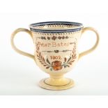 AN EARLY 19TH CENTURY TWIN HANDLED LOVING CUP signed 'Peter Bates' and dated 1802, with a pottery