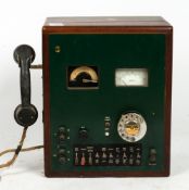 AN EARLY 20TH CENTURY OAK AND BAKELITE TELEPHONE EXCHANGE BOX with a volt meter and a pulses per