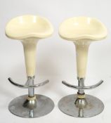A PAIR OF ITALIAN STYLE CHROME AND WHITE COMPOSITE ROTATING BAR STOOLS each 38cm wide x 75cm high