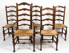 A SET OF FIVE LADDERBACK DINING CHAIRS with rush seats and turned supports to include one carver